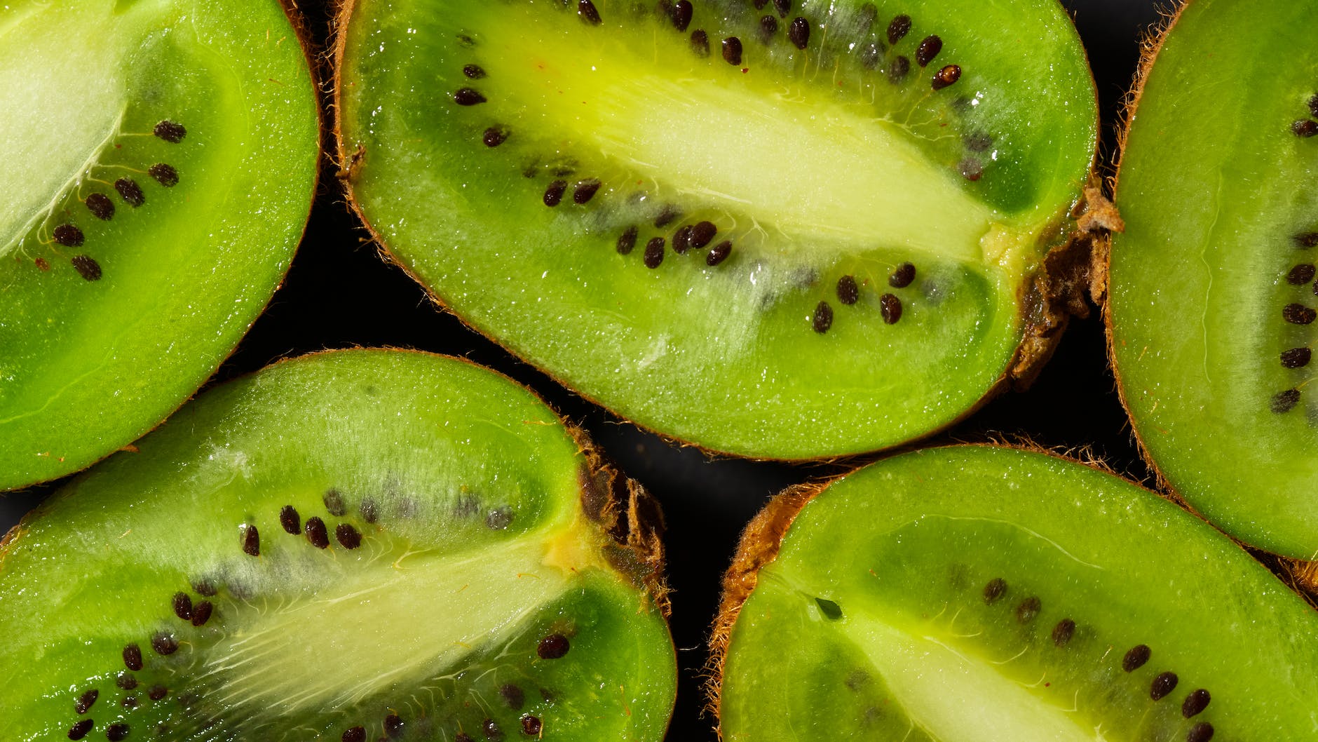 close up photo of kiwis with black seeds